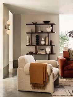 a living room filled with furniture and a book shelf on top of a wooden table