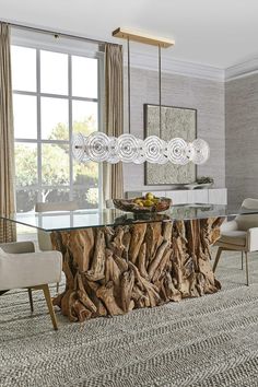 a dining room with a table made out of tree stumps and chairs around it