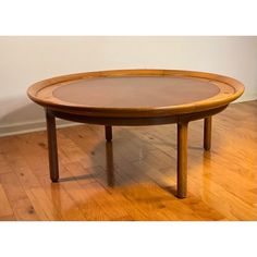 a table with a glass top sitting on a hard wood floor