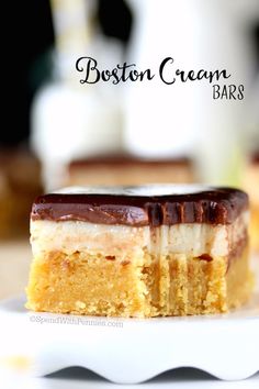 a close up of a piece of cake on a plate with the words boston cream bars in the background