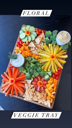 a platter filled with veggies and dips on top of a table