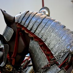 a close up of a horse wearing armor