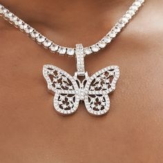 Introducing the Large Iced Butterfly Pendant, an eye-catching piece that sure to make a statement! Its stunning details give it a unique look that will stand out from any other piece in your collection. Crafted in 14k White Gold, the butterfly features hand-set stones and wings filled with our signature GLD stars for extra detail and shine. Pair it with the Iced Butterfly Diamond Prong Cuban Necklace- 6mm for the perfect set. This product is guaranteed for life - GLD will repair the item should Luxury Metal Jewelry With Rhinestones, White Iced Out Jewelry, Iced Out Pendant Jewelry For Party, Luxury Butterfly Shape White Gold Jewelry, Luxury Butterfly Shaped White Gold Jewelry, Luxury White Gold Butterfly Jewelry, Luxury Butterfly White Gold Jewelry, Iced Out Metal Pendant Jewelry, White Gold Rhinestone Pendant Jewelry