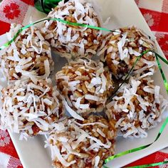 coconut truffles on a white plate with green ribbon and candy canes in the background