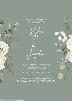 an elegant wedding card with white flowers and greenery on the front, blue background