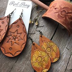 "Hand tooled leather earrings. Premium veg tanned leather. Handmade from start to finish. We love and take great care in what we do and it translates to every detail of your beautiful leather piece. These earrings aren Extra Large at approximately 3\" in length and 1.75\" wide. These are made to order. Hand tooled and dyed in a rich caramel brown with a floral motif and antiqued finish. These look great with any modern boho styles. If you love an extra large statement earring, these are for you! Bohemian Hand-tooled Leather Earrings, Rustic Hand Tooled Leather Earrings, Handmade Rustic Leather Earrings, Brown Leather Stamped Jewelry, Handmade Rust Leather Jewelry, Rustic Leather Stamped Jewelry, Hand Tooled Leather Earrings For Gift, Hand Tooled Leather Earrings As Gift, Everyday Hand Tooled Leather Jewelry