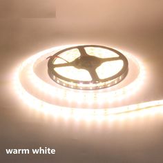 a white light that is on top of a wall with the words warm white written below it