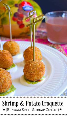 small appetizers with toothpicks are on a white plate