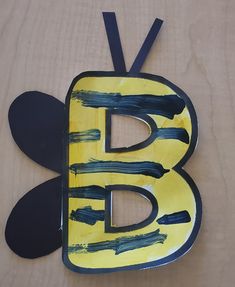 the letter b is painted yellow and black