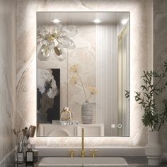 a bathroom sink sitting under a large mirror next to a vase with flowers on it