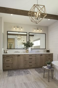 a bathroom with two sinks, mirrors and a bathtub in the middle of it