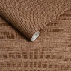 a close up view of a brown fabric with small squares on it's surface