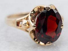 This stunning ring is crafted from luxurious yellow gold and set with a stunning garnet. Perfect for special occasions, this ring is sure to make a lasting impression.Metal: 10K Yellow GoldGem: Pyrope Garnet 3.83 CaratsGem Measurements: 8.2 x 10.0 mm, OvalRing Size: 7.50Marks: "10K PC" Stamped on the inside band Garnet Engagement Rings, Pyrope Garnet, Garnet Engagement Ring, Dome Ring, Watch Chain, Domed Ring, Garnet Gemstone, Ruby Ring, Cocktail Ring