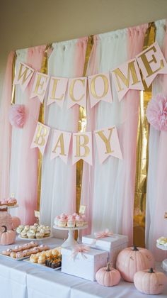 a baby shower party with pink and gold decorations