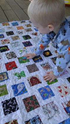 a young boy is playing with a quilt