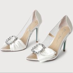 You'll Be Sending Out All The Luxe Vibes When You're Wearing The Betsey Johnson Sb-Moxie Ivory Satin Rhinestone Pointed-Toe Pumps! Clear Vinyl Shapes A Pointed-Toe Upper And A Classic Pump Silhouette, Trimmed With Sleek Woven Satin. A Decorative Bow And Sparkling Rhinestone Buckle Accent The Vamp For A Chic Finish! The Blue Soles Add The Cutest Something Blue To Your Wedding! 4.25" Wrapped Stiletto Heel. Cushioned Insole Rubber Sole Has Nonskid Markings Satin/Lucite Slip On Entry Pointed Toe Shoe Width - Medium Rhinestone Brooch Brand New Never Worn, Changed My Mind Last Minute About My Wedding Shoes And Wore Flats. No Box Or Tags. Perfect Bridal Shoes For An Elegant Bride White Rhinestone Shoe Clips, Elegant White Shoe Clips With Rhinestones, Elegant White Rhinestone Shoe Clips, Rhinestone Wedding Shoes For Bridal Shower, White Crystal Embellished Shoe Clips For Formal Occasions, White Crystal Embellished Shoe Clips For Wedding, White Embellished Shoe Clips For Formal Occasions, Glamorous White Shoe Clips For Wedding, White Crystal-embellished Wedding Shoes