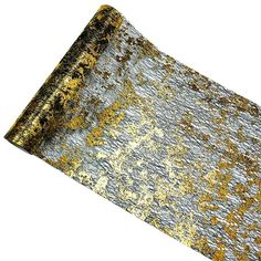 an old, worn out piece of metal with gold and silver flecks on it