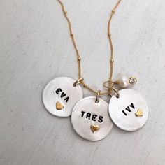 These charming fine (.999) silver tags are double-sided and custom stamped with name and a 22kt gold heart charm on one side and the date of birth (or any other message) on the other side. Tags come in 2 sizes: Small (5 - 6 letters size of a dime) Medium (6-7 letters, size of a nickel) Large (9-10 letters, size of a quarter) Stone not included with this Necklace. ~ Make it uniquely yours by visiting our Charm and Stone categories ~ Our personalized jewelry is made by hand. Please allow 1 to 2 we Stamping Jewelry, Necklace With Kids Names, Mom Necklace Personalized, Mantra Bands, Metal Stamped Jewelry, Rear View Mirror Decor, Date Of Birth, Hand Stamped Jewelry, Mom Necklace