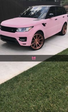 a pink range rover parked in front of a black fence with gold rims on it