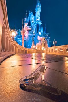 a glass object sitting on the ground in front of a castle