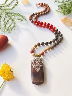 I make my own decisions with confidence and conviction. I allow my creativity to flow through me freely. I am confident in my ability to succeed. My sacral chakra is balanced. This purchase includes: Gemstone Half Mala, baggie, card including using your mala, intention setting and properties. GEMSTONES Rudraksha: Rudraksha seeds grow inside of what look like blueberries on trees in South East Asia. In Buddhism and Hinduism, the beads are believed to provide inner calm, peace, and free one from n Long Healing Necklace With Natural Stones, Nature-inspired Agate Beaded Necklace With Natural Stones, Holistic Jewelry With 108 Beads For Rituals, Brown Gemstone Beads Nature-inspired Necklace, Nature-inspired Brown Gemstone Bead Necklace, Earthy Amber Necklace With Natural Stones, Earthy Crystal Necklaces For Healing With Natural Stones, Earthy Crystal Necklaces With Natural Stones For Healing, Earthy Agate Beaded Necklaces