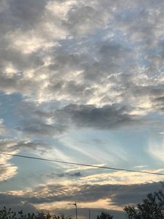 the sky is filled with clouds and power lines