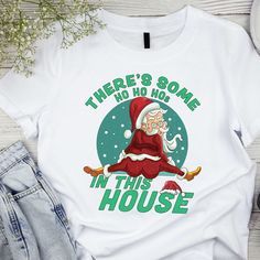 Get into the holiday spirit with our "There's Some Ho Ho Ho's in This House" shirt! Featuring a funny twerking Santa, this unique Christmas tee is perfect for Christmas parties, family gatherings, or as a fun winter season gift. Spread the Christmas vibes with this hilarious design! 🎅🎄 🌟 Welcome to BLG Design Lab! 🌟 We are a small family business dedicated to crafting custom designs on high-quality t-shirts, sweatshirts, long sleeves, tank tops, V-necks, youth and toddler shirts, babysuits, tote bag and towels. Our goal is to provide you with unique, stylish, and comfortable apparel that you'll love. Why Choose Us? 💎 Premium Quality: We use top-quality materials and DTF technology for vibrant, long-lasting prints. 🎨 Unique Designs: Each design is created with attention to detail and Funny Christmas Tshirts, Christmas Tshirt, In This House, Design Lab, Christmas T Shirt, Christmas Tees, High Quality T Shirts, Unique Christmas, Funny Christmas