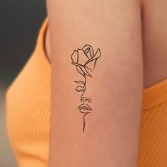 a woman's arm with a rose tattoo on the left side of her body