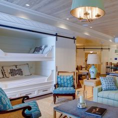 a living room filled with furniture and lots of shelves on the wall next to each other