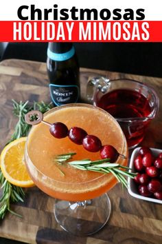 a holiday mimosa is garnished with cranberries and orange slices