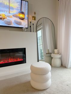 a living room with a fire place in the center and a mirror on the wall