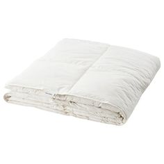 a white comforter is folded on top of a pile of pillows and blankets in front of a white background