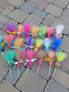 there are many different colored hair bows on the ground together and one is tied to a string