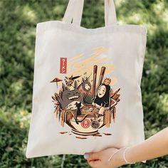 Our Ghibli Inspired Ramen 100% cotton bag comes in one size - 15" x 16"- perfect for everyday wear. While the canvas material will show off your designs in great colors, it's durable and will last for years. The bag features 20" handles (made from the same canvas), making it easy to carry even with a week's worth of shopping in Ghibli inspired style! .: 100% cotton canvas .: Heavy fabric (12 oz/yd² (406.9 g/m .: Sewn-in label Casual Canvas Bag For Gift, Casual Canvas Bag With Graphic Print, Casual Canvas Shoulder Bag With Graphic Print, Cotton Shoulder Bag With Graphic Print, Travel Cotton Shoulder Bag With Graphic Print, White Cotton Shoulder Bag With Graphic Print, Daily Use Cotton Shoulder Bag With Graphic Print, Daily Use Canvas Bag With Eco-friendly Ink, Casual Canvas Softback Bag For Gift