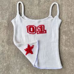 a knitted tank top with the word goal on it and a canadian maple leaf