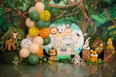 an animal themed birthday party with balloons and decorations