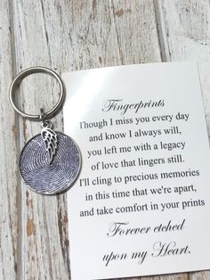 a fingerprint keychain with a poem written on it