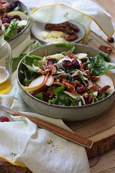 a salad with apples, cranberries and pecans