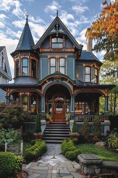 a large house with lots of windows on the front and side of it's roof