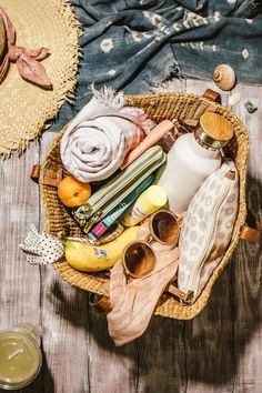 a basket filled with lots of different items on top of a wooden table