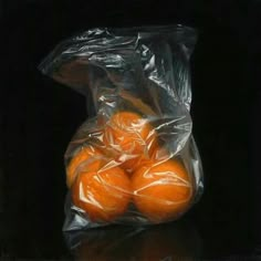 a bag full of oranges sitting on top of a table