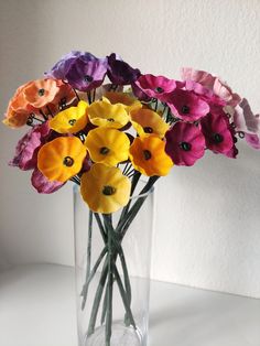 a vase filled with colorful flowers on top of a table