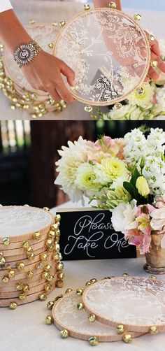 a table topped with lots of white and pink flowers next to cake plates on top of a table