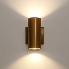 a wall mounted light on the side of a white wall