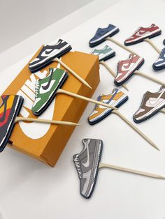 several pairs of shoes are on toothpicks in a box with matchesticks