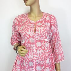 This handblockprinted floral dress in a soft cotton is so beautiful. Details with white lace.  It is cut on the bias so it has a very easy fit. It will fit where needed and drape beautifully  where you don't need extra fabric. It's really a flattering dress. Fabric is completely soft and natural. No chamicals have been added. 100% pure cotton.  Sizes; Small - 38 Chest size Medium; 40 Chest size Large; 42 Chest size Extra Large; 44 Chest size Sleeve Length; 3/4 Long Wash Care Instructions; First few wash separately. Cold Machine wash. Do not Bleach. Dry in shade. Pink Floral Print Cotton Kurta, Pink Cotton Kurta With Floral Print, Cotton Tunic Dress With Lace Trim, Pink Cotton Tunic Kurta, Spring Cotton Kurta With Block Print, White Cotton Dress With Block Print, Hand Printed Cotton Dresses, Flattering Dress, Cotton Dress Summer