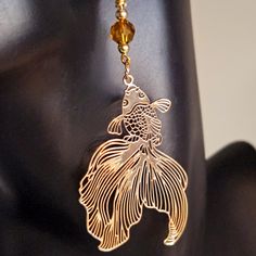 "Enjoy my \"Golden Fantail Filigree Earrings\" . These earrings are stunning  and are accented with a bronze Austrian Crystal . Ear wire is gold plated sterling silver. The shimmering of the filigree design create a beautiful aura that symbolizes the metallic scales of the fantail. The fantail goldfish symbolizes good luck and fortune.  Wear them with any ensemble and at any occasion.  Thank you for shopping at CraftsRU!" Elegant Brown Copper Wire Jewelry, Elegant Nickel-free Copper Wire Earrings, Gold Wire Wrapped Adjustable Crystal Earrings, Gold Crystal Pierced Earrings As Gift, Adjustable Gold Wire Wrapped Crystal Earrings, Gold Crystal Pierced Earrings For Gift, Adjustable Gold Metal Crystal Earrings, Elegant Silver Earrings With Copper Wire, Gold Wire-wrapped Crystal Earrings