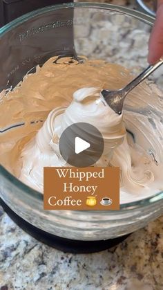 someone mixing whipped honey in a bowl with a spoon