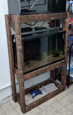 a fish tank sitting on top of a wooden shelf