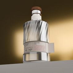 a silver bottle with a wooden top on a table next to a brown and white wall